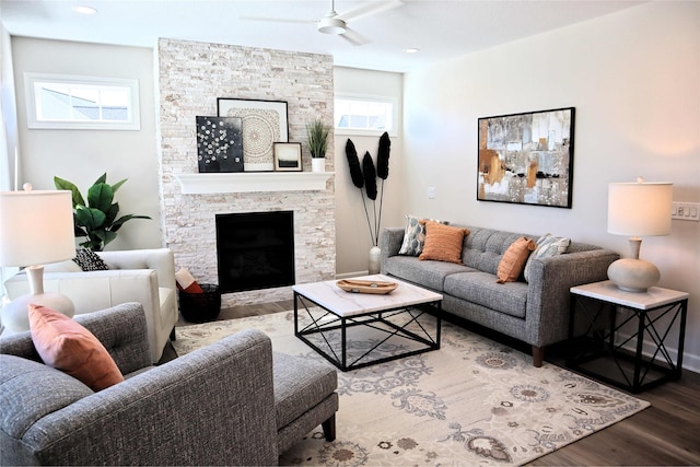 living room with ceiling fan, a fireplace, a healthy amount of sunlight, and wood-type flooring