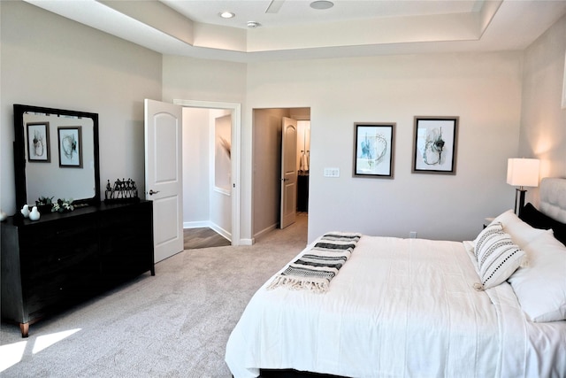 carpeted bedroom featuring a tray ceiling