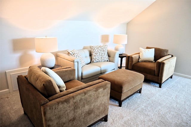 carpeted living room with vaulted ceiling