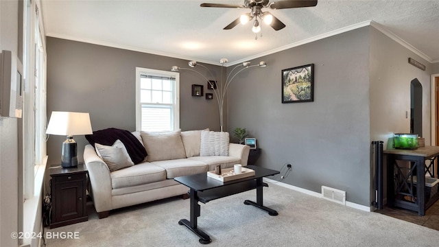 living room featuring crown molding, ceiling fan, and light colored carpet