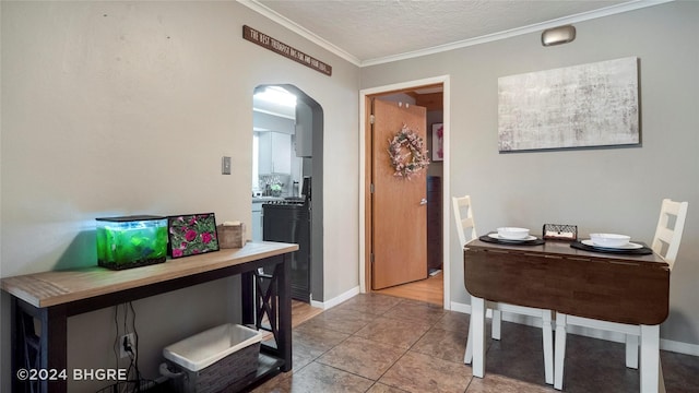 interior space with tile patterned flooring, crown molding, and a textured ceiling