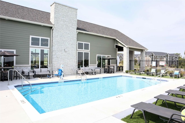 view of swimming pool with an outdoor living space and a patio