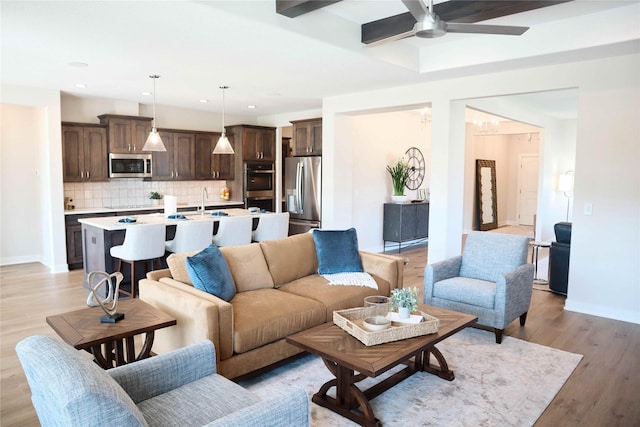 living room featuring ceiling fan and light wood-type flooring