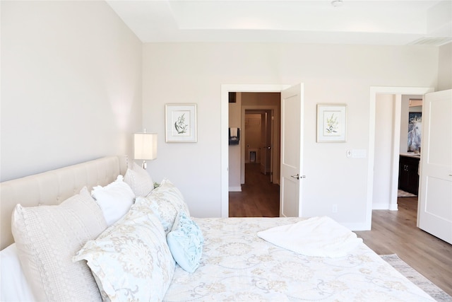 bedroom with hardwood / wood-style floors