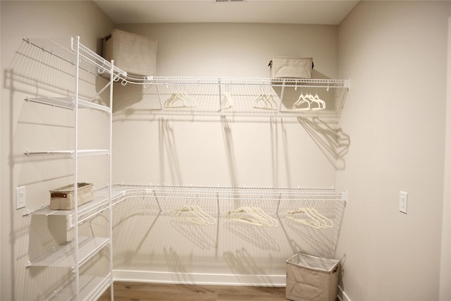 spacious closet with hardwood / wood-style flooring