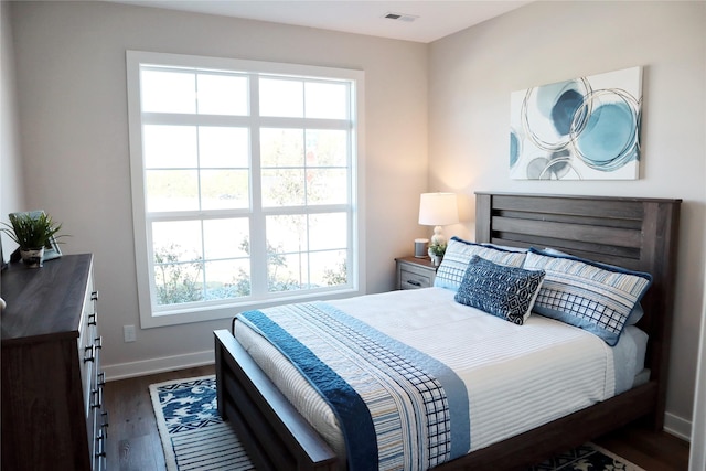 bedroom with dark wood-type flooring