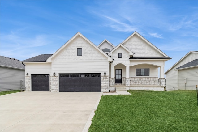 view of front of property with a porch, a garage, and a front yard