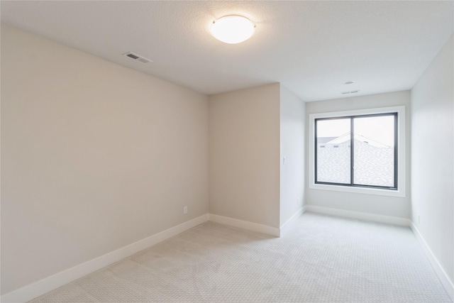 unfurnished room with light carpet