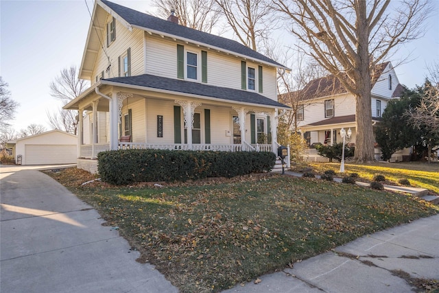 farmhouse-style home featuring an outbuilding, a front yard, and a garage