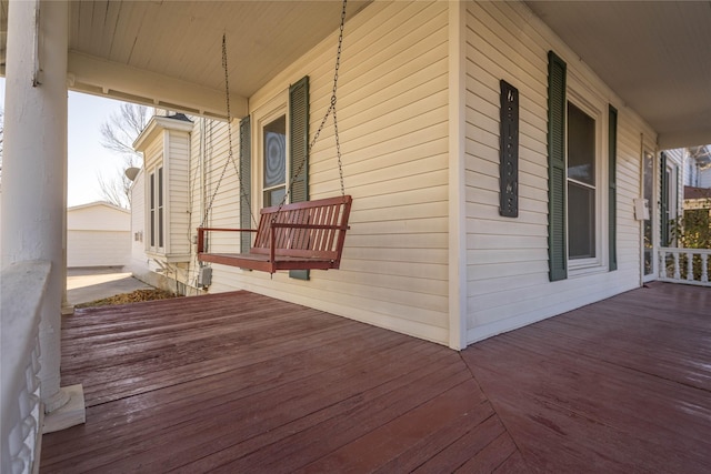 wooden terrace featuring covered porch