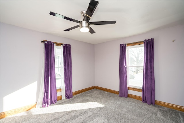 empty room featuring ceiling fan and light carpet