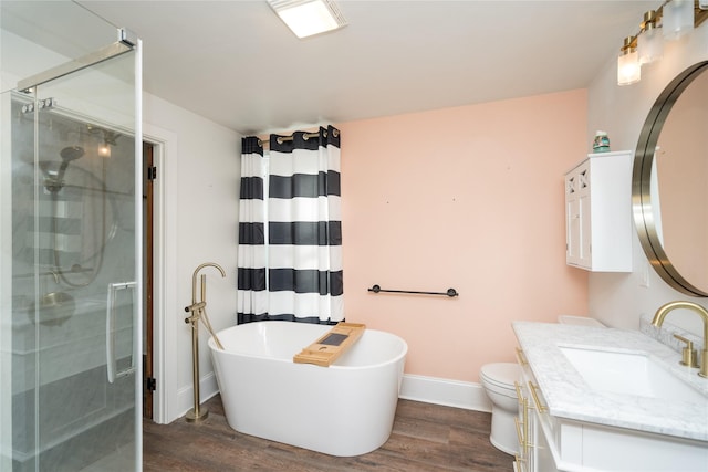 full bathroom featuring hardwood / wood-style floors, vanity, separate shower and tub, and toilet