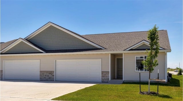 view of front of property with a front lawn and a garage