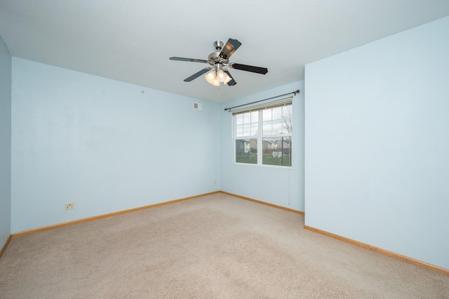 spare room featuring ceiling fan and carpet floors