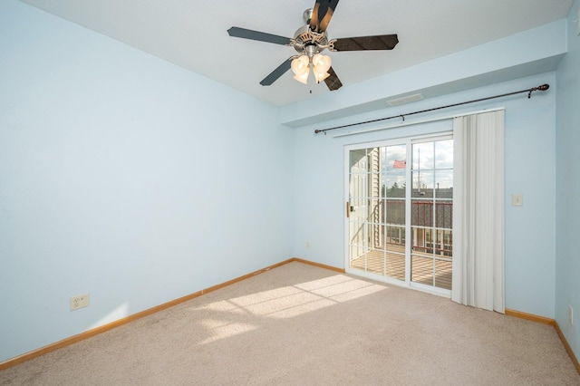 carpeted spare room featuring ceiling fan