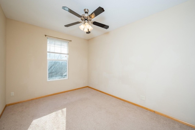 spare room featuring carpet and ceiling fan