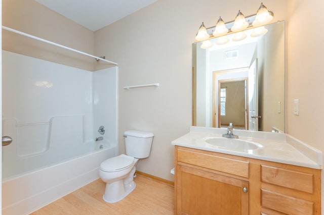 full bathroom with vanity, wood-type flooring, shower / bathtub combination, and toilet