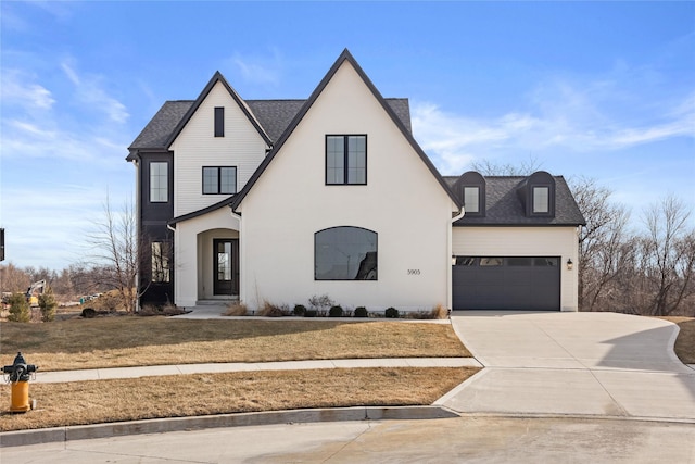 view of front of property with a garage and a front lawn