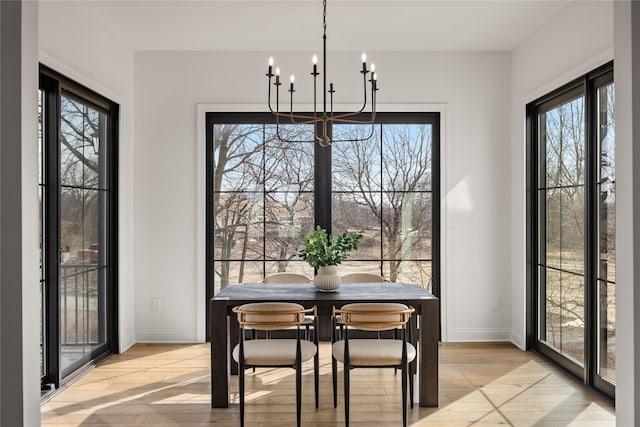 dining area featuring a notable chandelier and light hardwood / wood-style floors