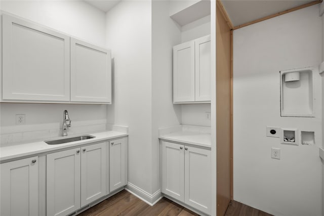 washroom with dark hardwood / wood-style floors, sink, cabinets, washer hookup, and electric dryer hookup