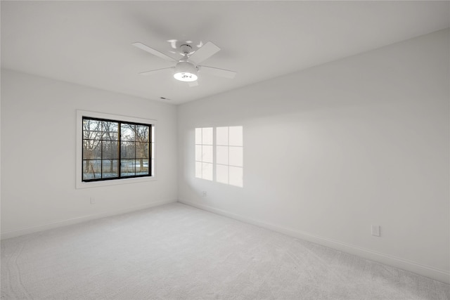 unfurnished room with light carpet and ceiling fan