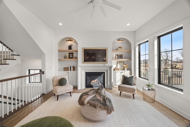 living area featuring hardwood / wood-style floors and built in features