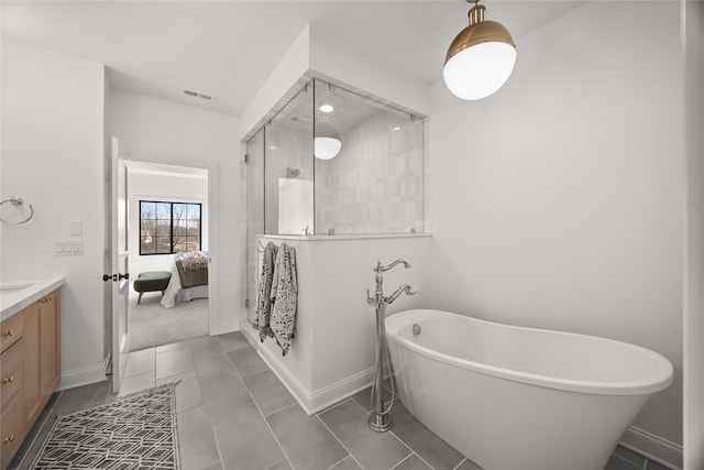 bathroom with vanity, tile patterned floors, and shower with separate bathtub