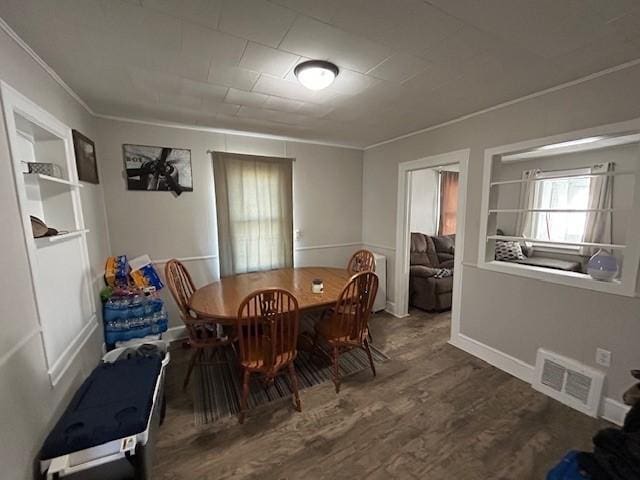 dining room featuring crown molding and wood-type flooring