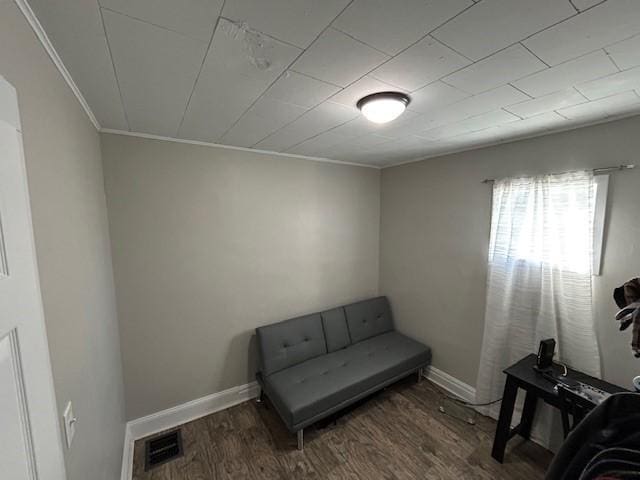 sitting room featuring crown molding and dark wood-type flooring