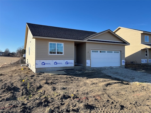 view of front of property featuring a garage and central air condition unit