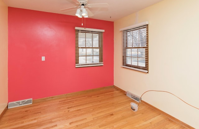 spare room with hardwood / wood-style floors and ceiling fan