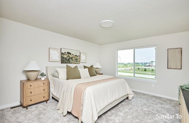 carpeted bedroom with a textured ceiling