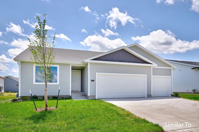 view of front of home with a front lawn and a garage