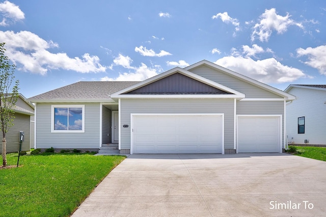 view of front of property with a garage and a front yard