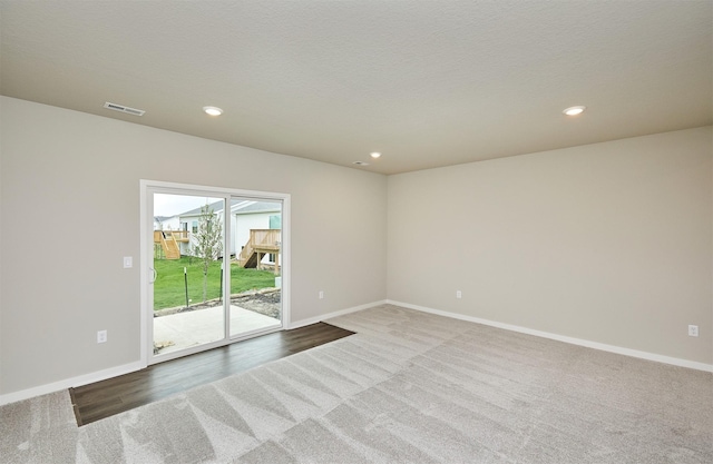 carpeted spare room with visible vents, recessed lighting, and baseboards
