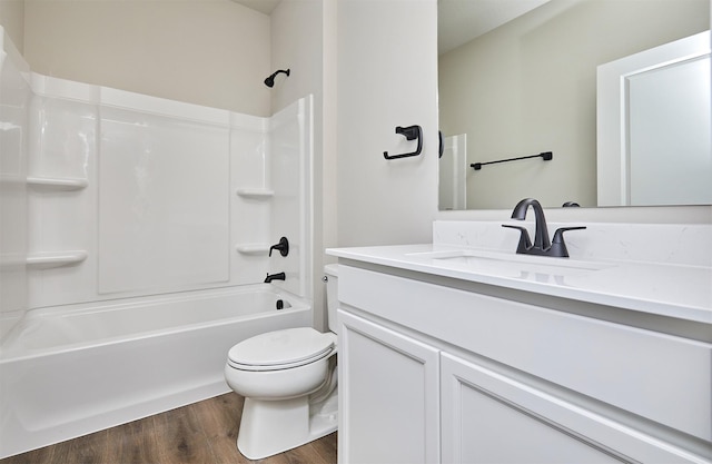 bathroom with vanity, shower / bathing tub combination, toilet, and wood finished floors
