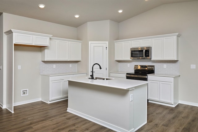 kitchen with a sink, stainless steel appliances, white cabinetry, tasteful backsplash, and a center island with sink