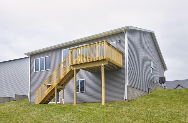 rear view of house featuring central AC unit, a yard, stairway, and a deck