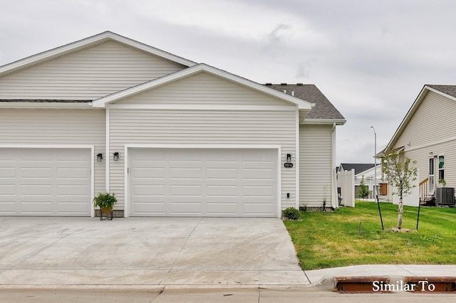 view of front of house featuring a front yard, a garage, and central AC unit