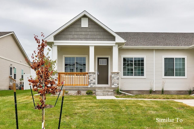 craftsman inspired home featuring a front yard and covered porch