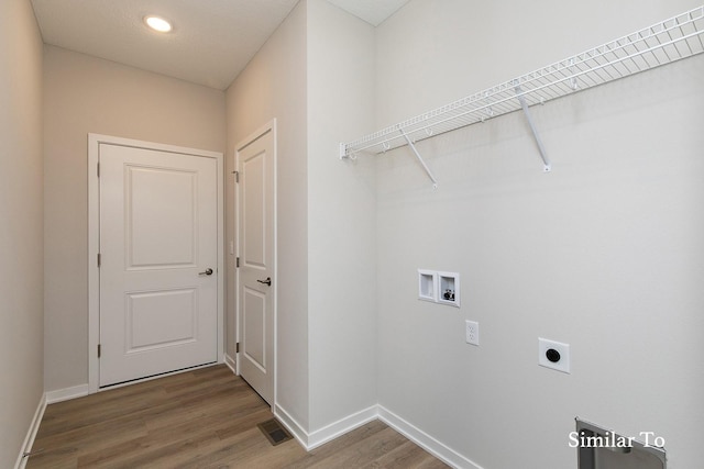 clothes washing area featuring hookup for an electric dryer, wood-type flooring, and hookup for a washing machine