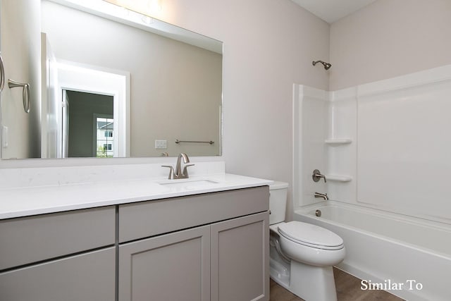 full bathroom with vanity, toilet, wood-type flooring, and washtub / shower combination