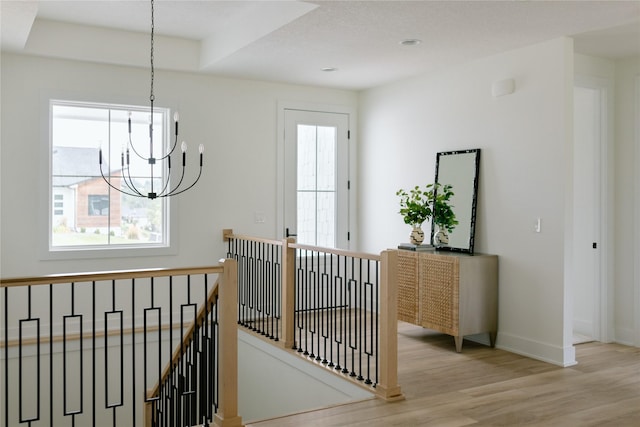 interior space with a chandelier, light hardwood / wood-style floors, and a wealth of natural light