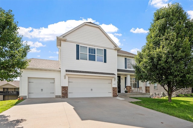 view of front of property featuring a garage and a front lawn