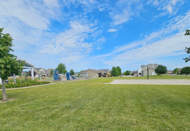 view of yard with basketball court and a playground