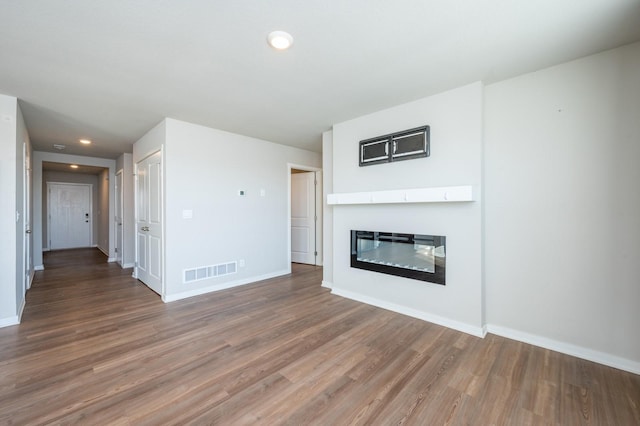 unfurnished living room with hardwood / wood-style floors