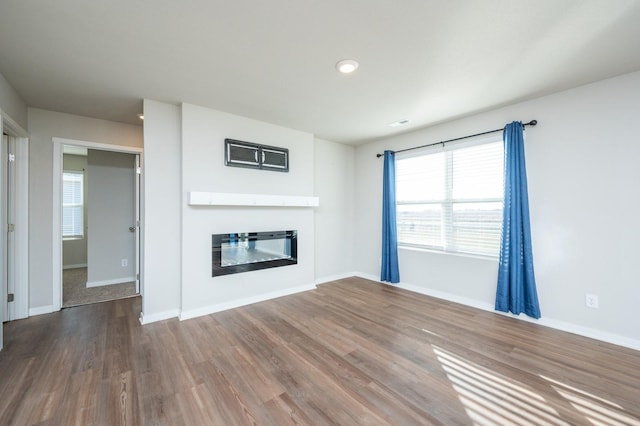 unfurnished living room featuring wood-type flooring