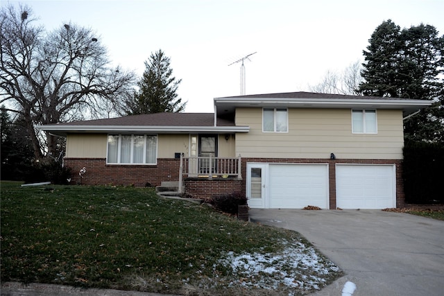 tri-level home featuring a garage and a front lawn