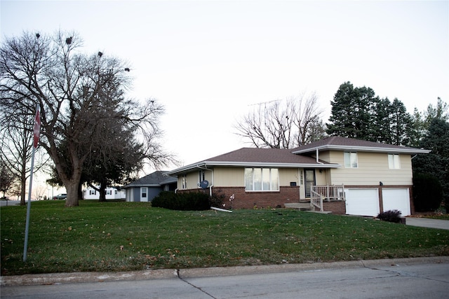 view of front facade with a garage and a front lawn