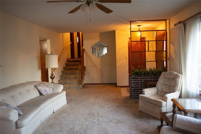 carpeted living room featuring ceiling fan, a healthy amount of sunlight, and a fireplace